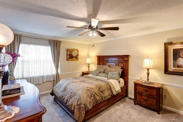 a bedroom with a bed flat screen tv and window
