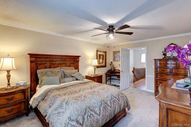 a bedroom with bed and a chandelier