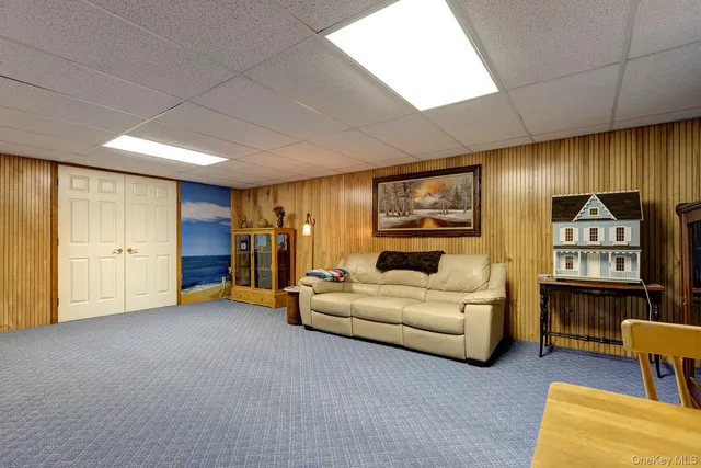 a living room with furniture and a bookshelf