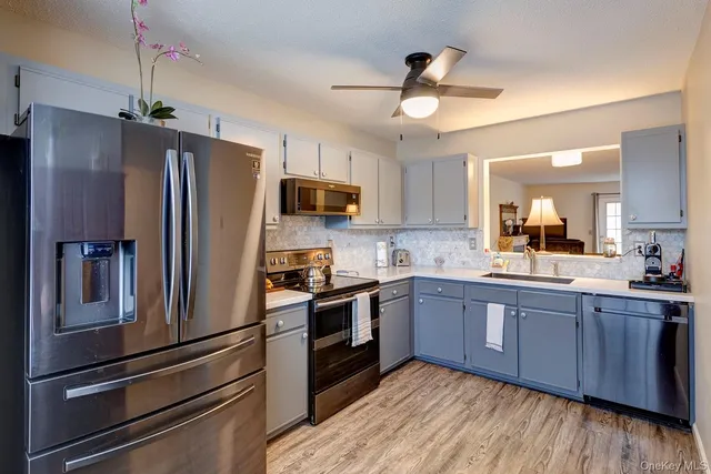 a kitchen with stainless steel appliances and wooden cabinets