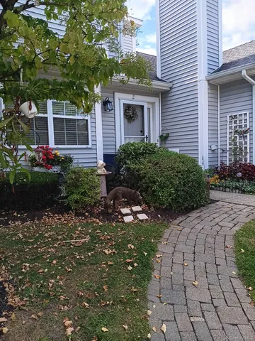 a view of a house with a backyard and garden