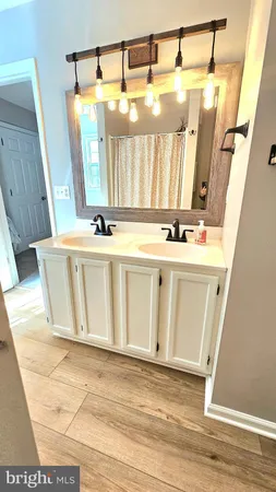 a view of a bathroom with a sink and a mirror