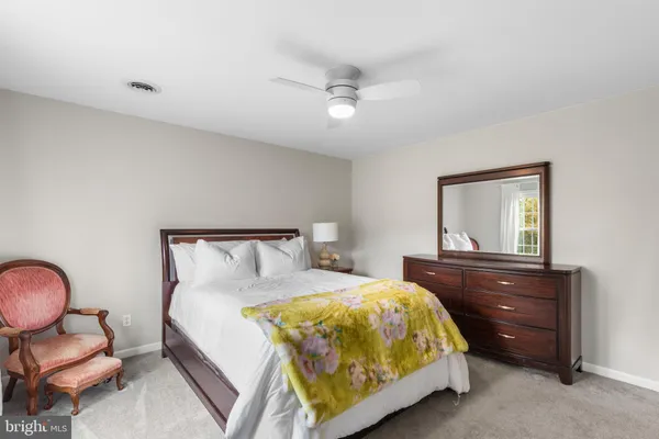 a bedroom with a bed and dresser
