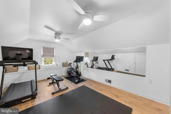 a room with gym equipment and a flat screen tv