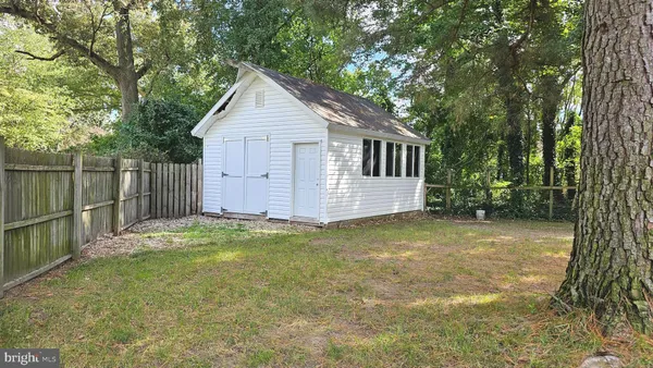 a backyard of house with a slide and large trees