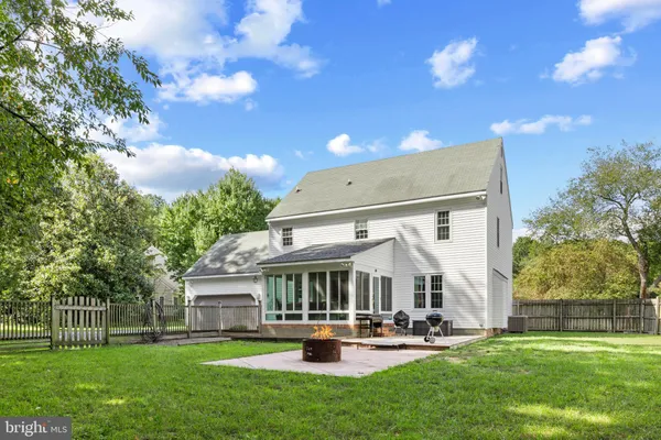a view of a house with patio and a yard