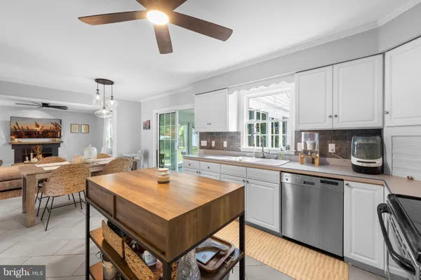 a kitchen with a stove a sink dishwasher and a refrigerator