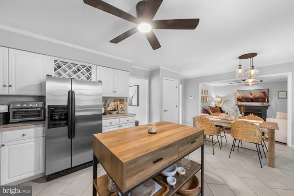 a kitchen with a table chairs refrigerator and microwave