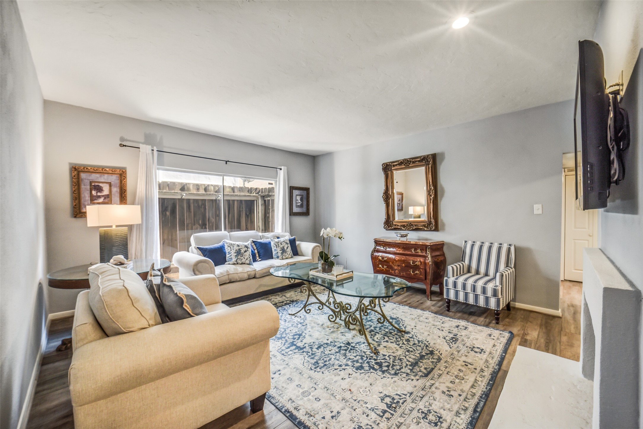 2100 Tanglewilde Street, Unit 591 Houston, TX 77063 - Photo 2 of 18 Light-filled corner residence featuring an expansive family/living room. Sliding glass door in the back leads to your fully fenced-in patio space. Space offers room for table and chairs to enjoy the outdoors. Large rooms offers options for different furniture configurations.