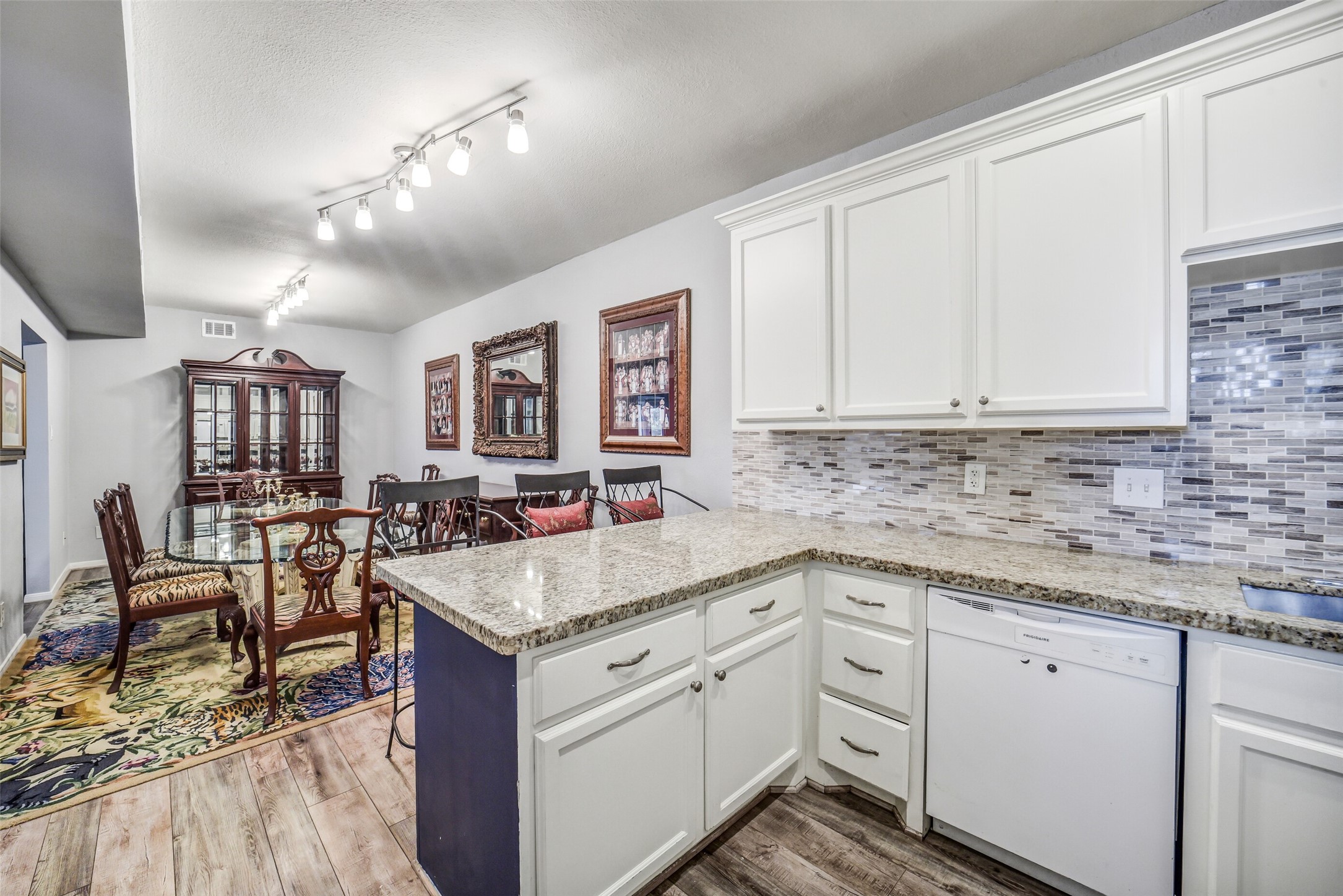 2100 Tanglewilde Street, Unit 591 Houston, TX 77063 - Photo 8 of 18 Another view of the fabulous kitchen highlighting the granite counters, ample prep space, and direct flow to the dining and living areas make this kitchen both practical and inviting.