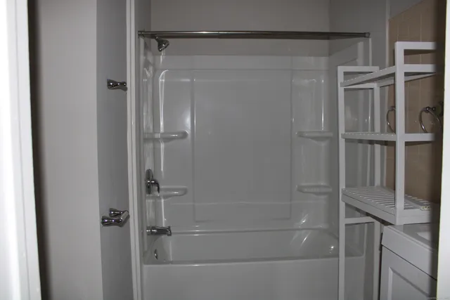 a bathroom with a glass shower door
