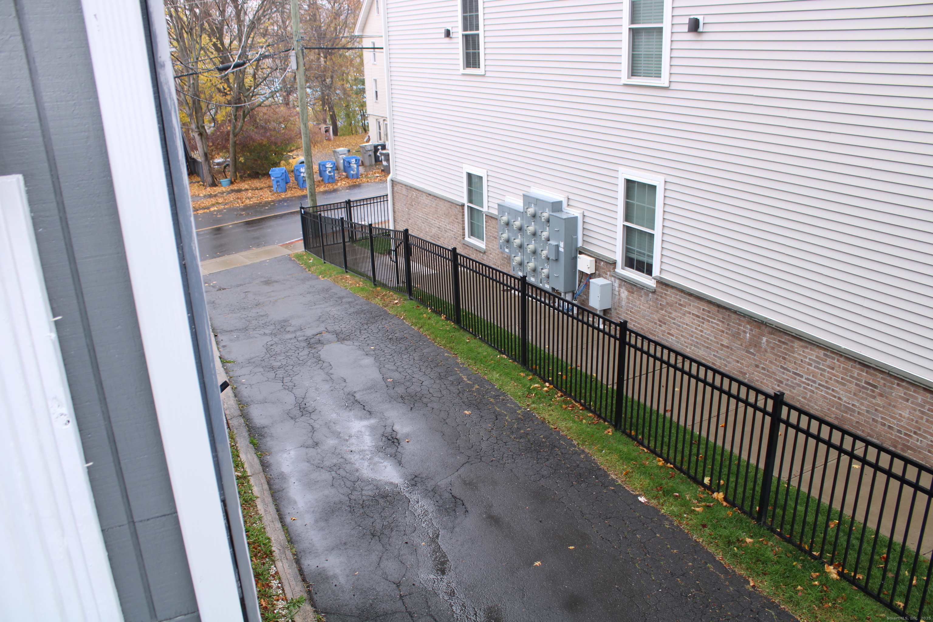 42 Summer Street, Unit 5 Bristol, CT 06010 - Photo 14 of 15 a view of a porch with wooden floor and fence