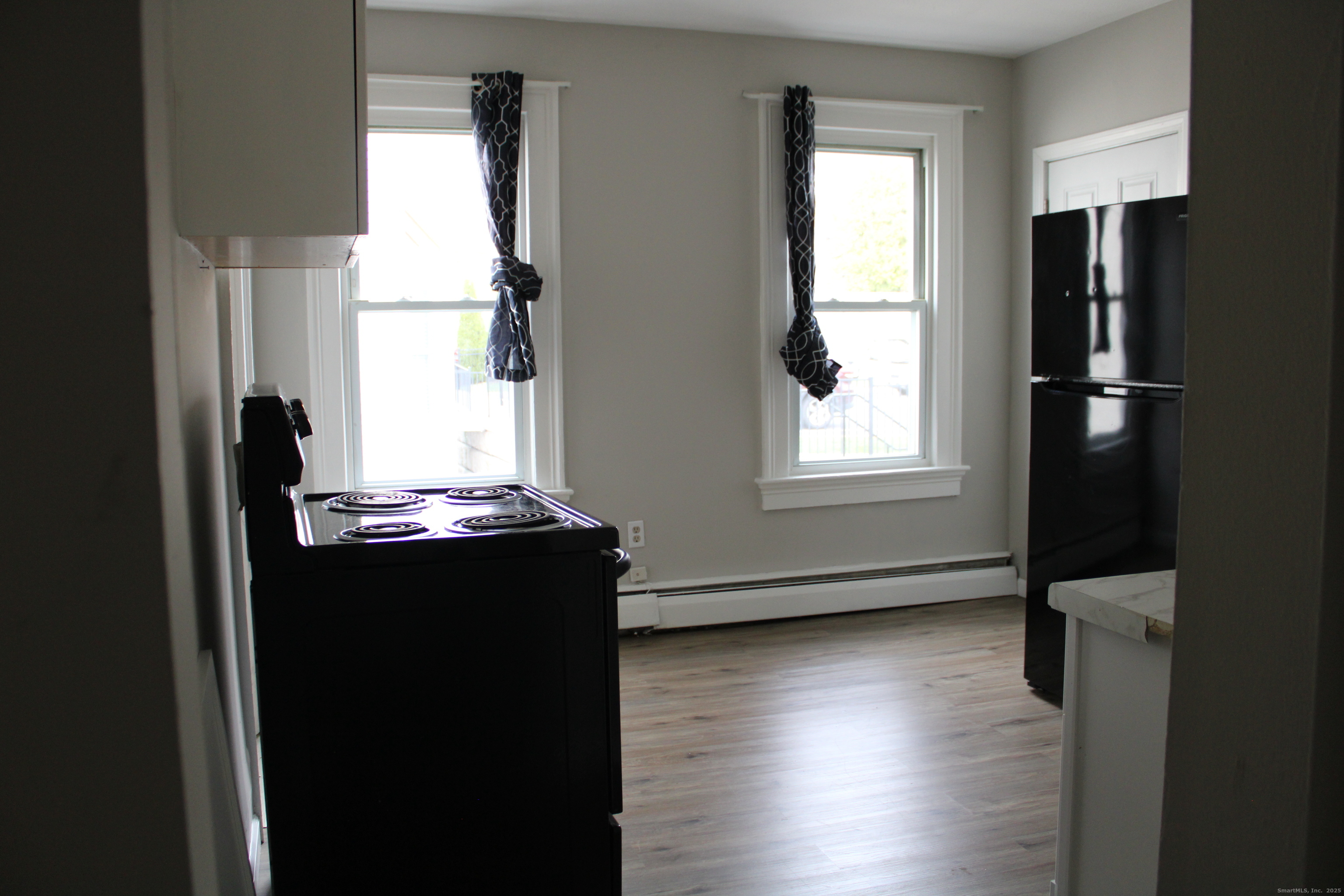42 Summer Street, Unit 5 Bristol, CT 06010 - Photo 4 of 15 a view of an empty room with wooden floor and a window