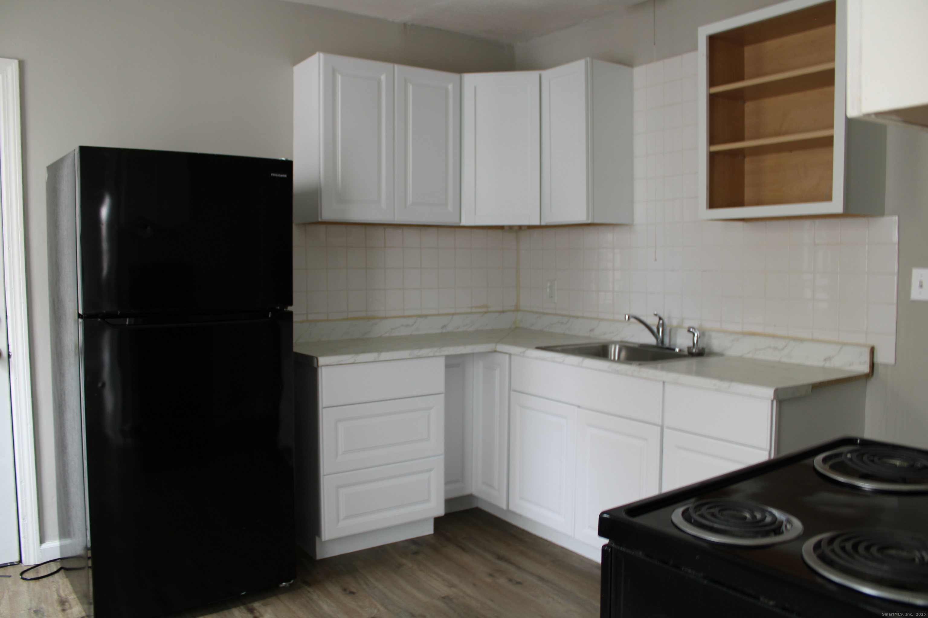 42 Summer Street, Unit 5 Bristol, CT 06010 - Photo 5 of 15 a kitchen with a refrigerator and a stove