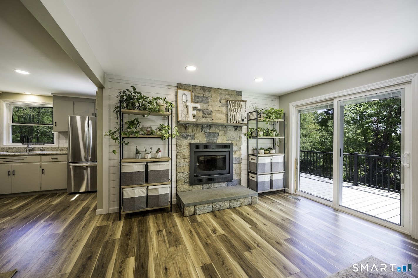 394 Brainard Hill Road Haddam, CT 06441 - Photo 6 of 23 a view of a livingroom with a fireplace wooden floor and window