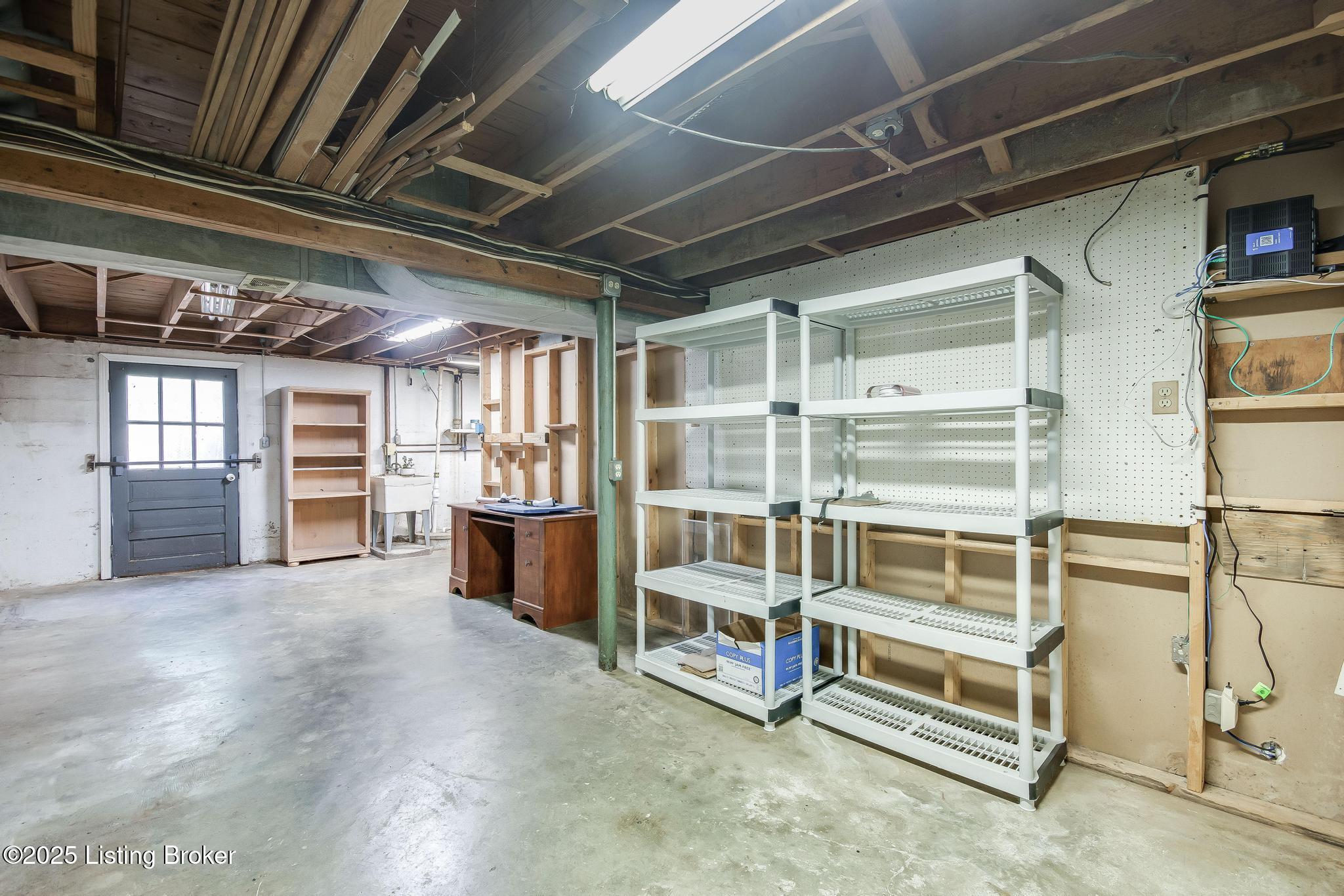 9611 Fairground Road Louisville, KY 40291 - Photo 36 of 57 Partially Unfinished Walkout Basement with HVAC unit, washer and dryer hookups, hot and cold sink and lots of additional storage.