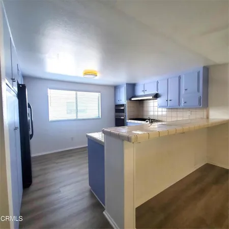 a kitchen with wooden cabinets and stainless steel appliances