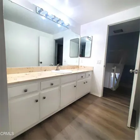 a spacious bathroom with a double vanity sink and mirror