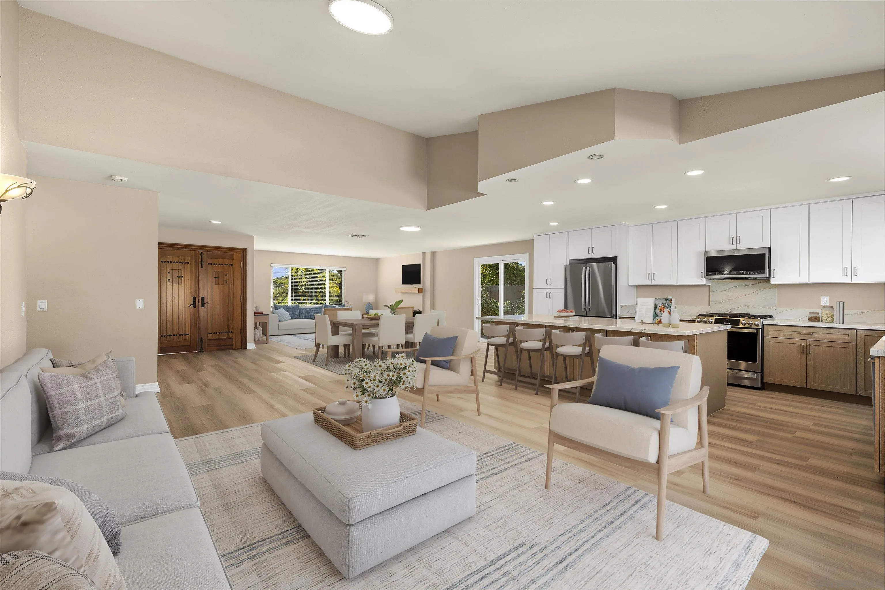 a living room with furniture wooden floor and kitchen view