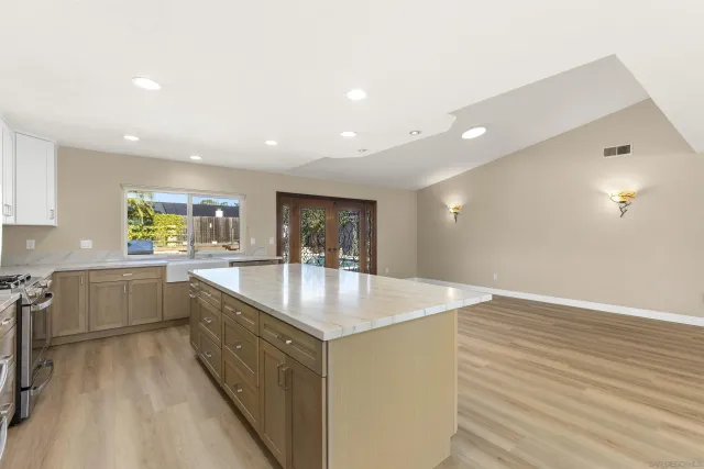 a kitchen with counter top a sink and dishwasher