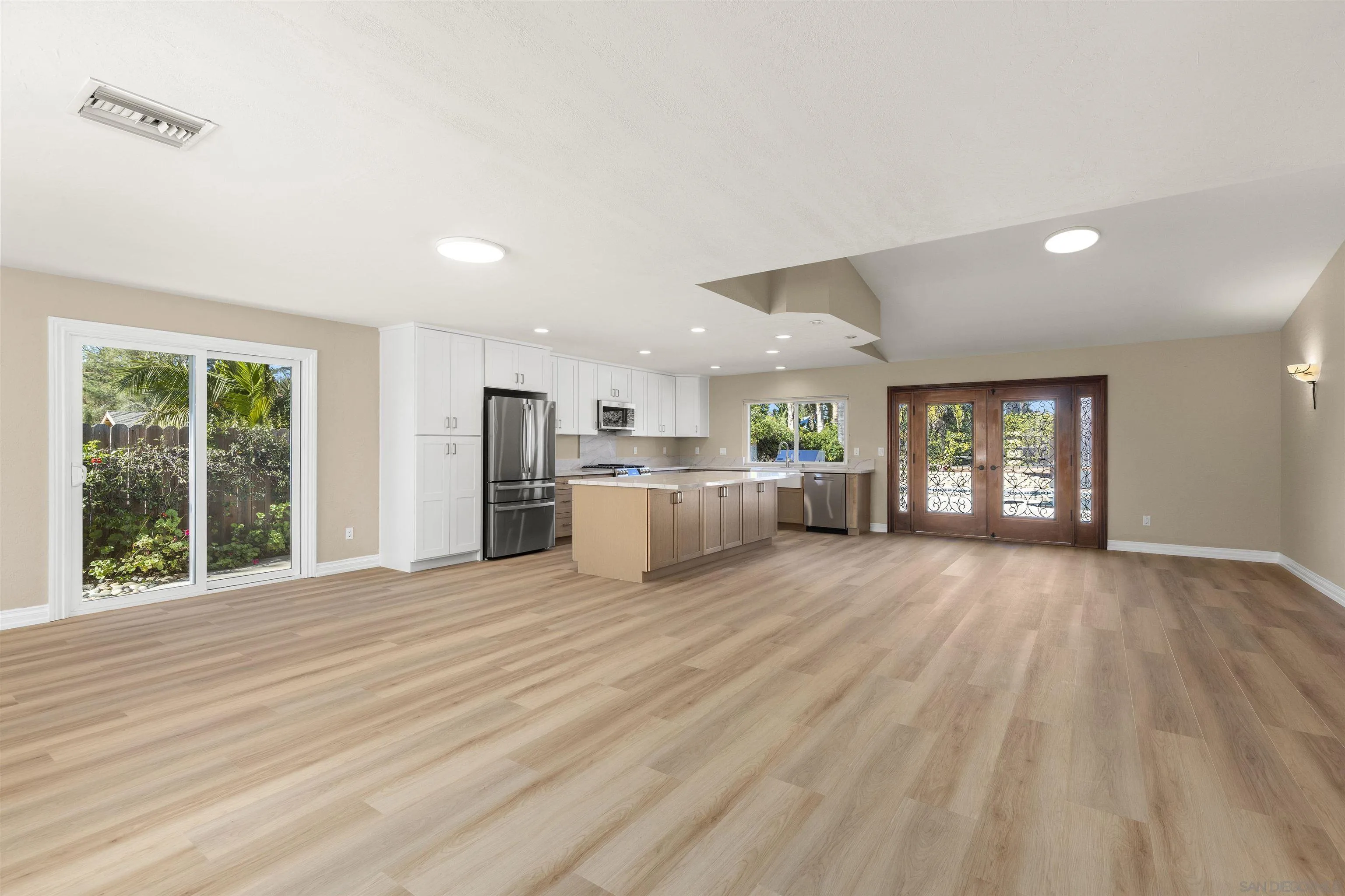 1510 Orangeview Drive, Unit 12 Encinitas, CA 92024 - Photo 13 of 55 a view of an empty room with window and wooden floor