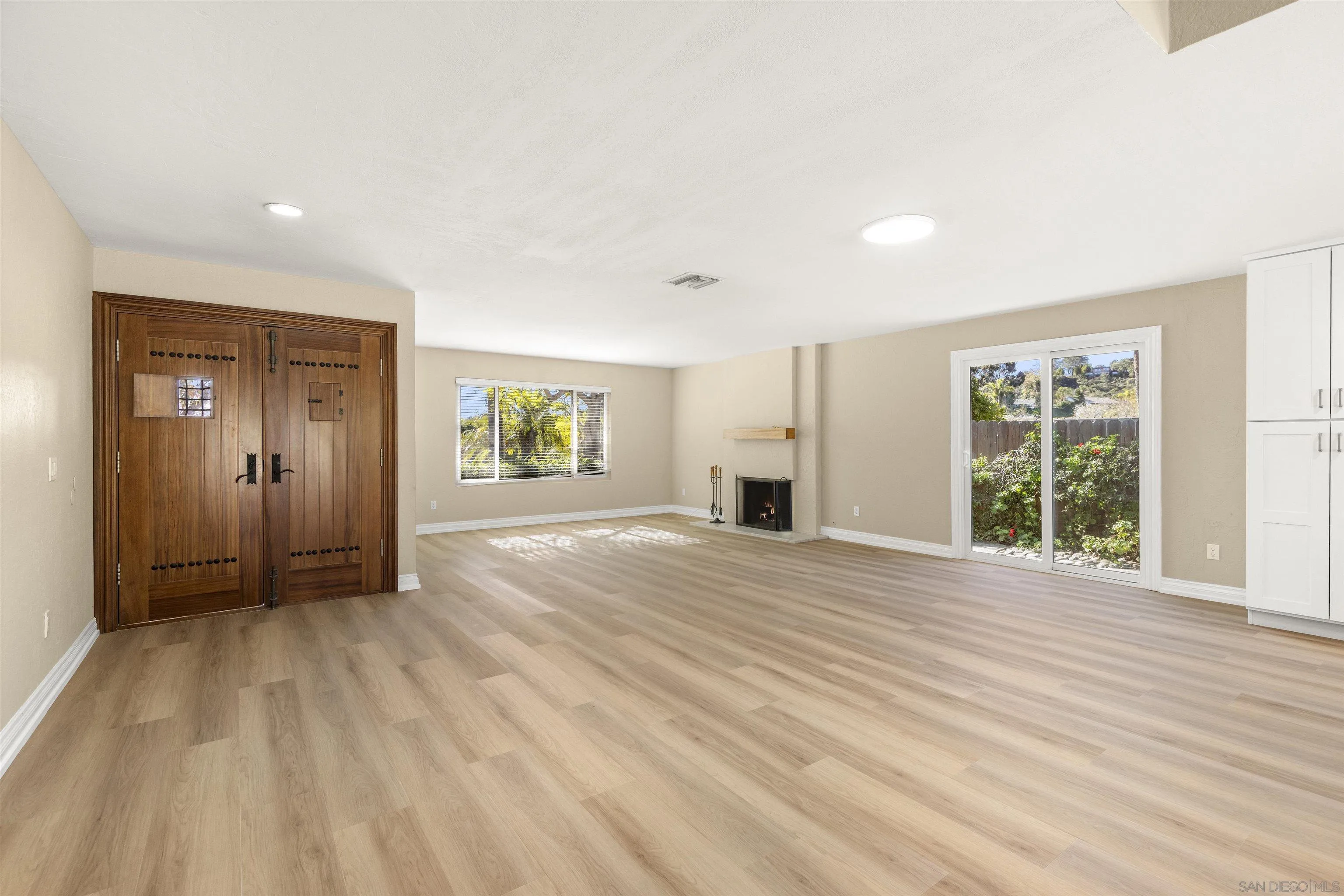 1510 Orangeview Drive, Unit 12 Encinitas, CA 92024 - Photo 14 of 55 a view of an empty room with a window and wooden floor