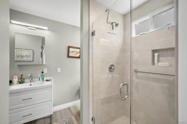 a bathroom with a shower vanity and a sink