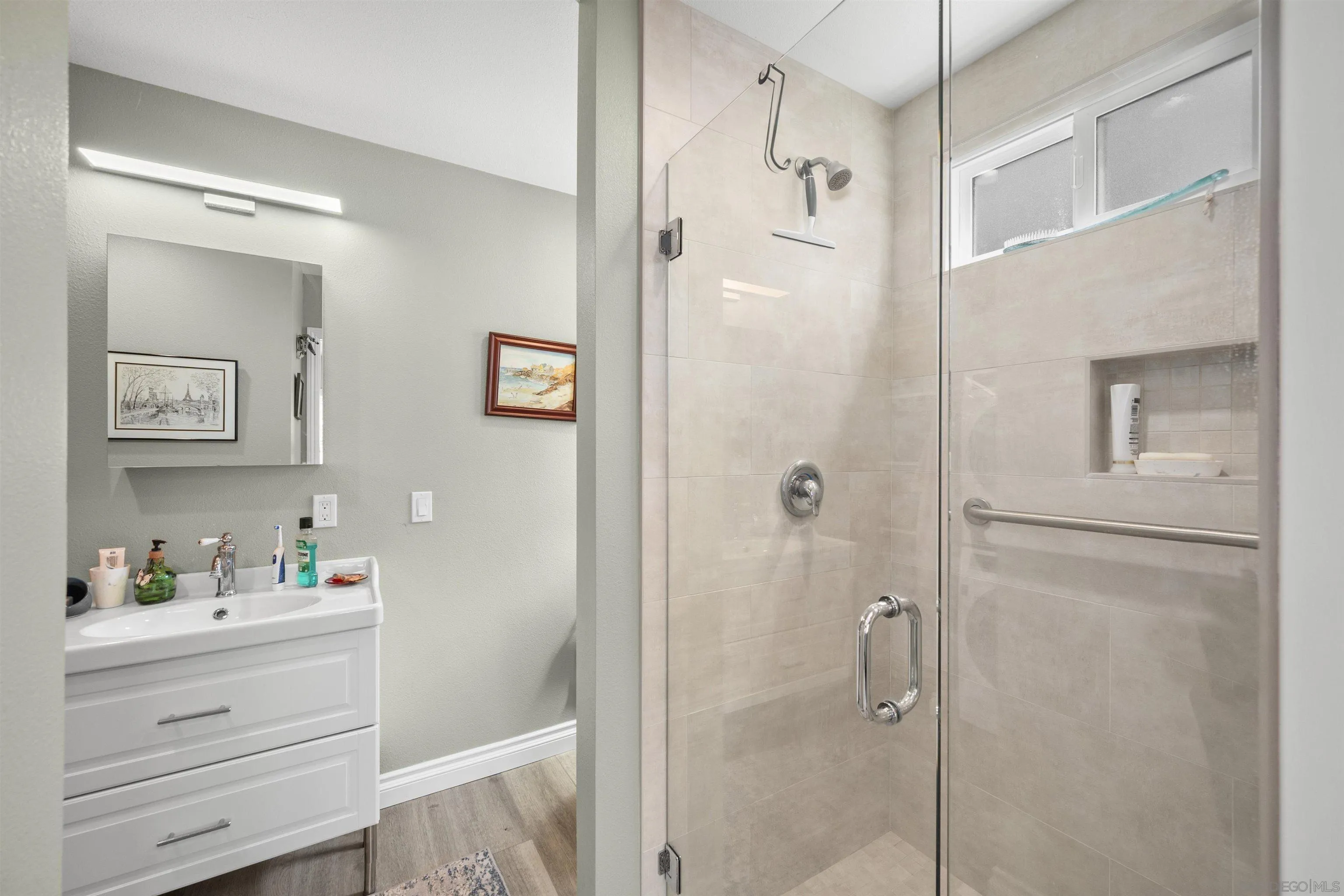 1510 Orangeview Drive, Unit 12 Encinitas, CA 92024 - Photo 15 of 19 a bathroom with a shower vanity and a sink