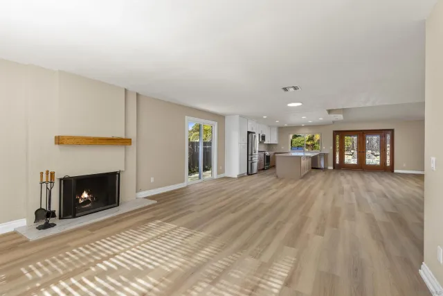 a view of empty room with a fireplace
