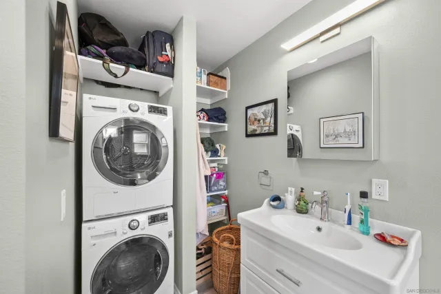 a utility room with sink dryer and washer