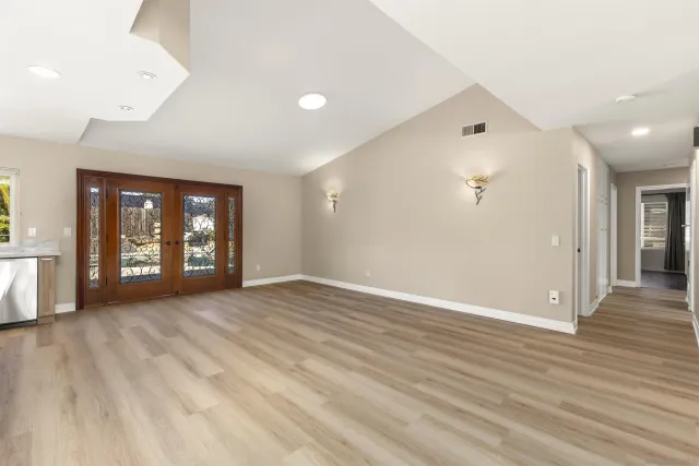 wooden floor in an empty room with a window