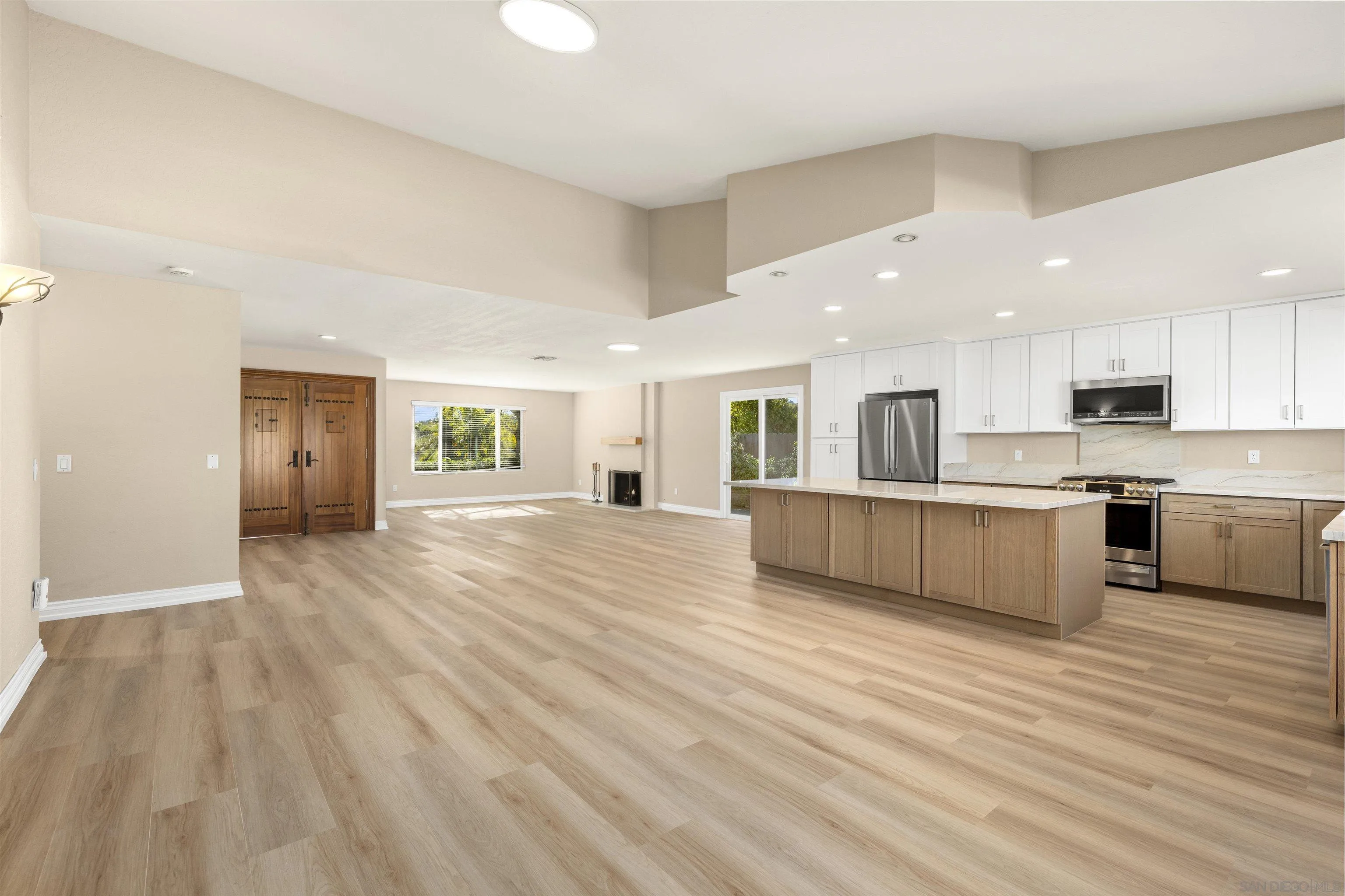 1510 Orangeview Drive, Unit 12 Encinitas, CA 92024 - Photo 2 of 55 a view of kitchen with granite countertop white cabinets and refrigerator