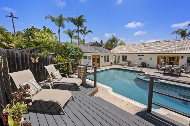 a view of house with swimming pool outdoor seating