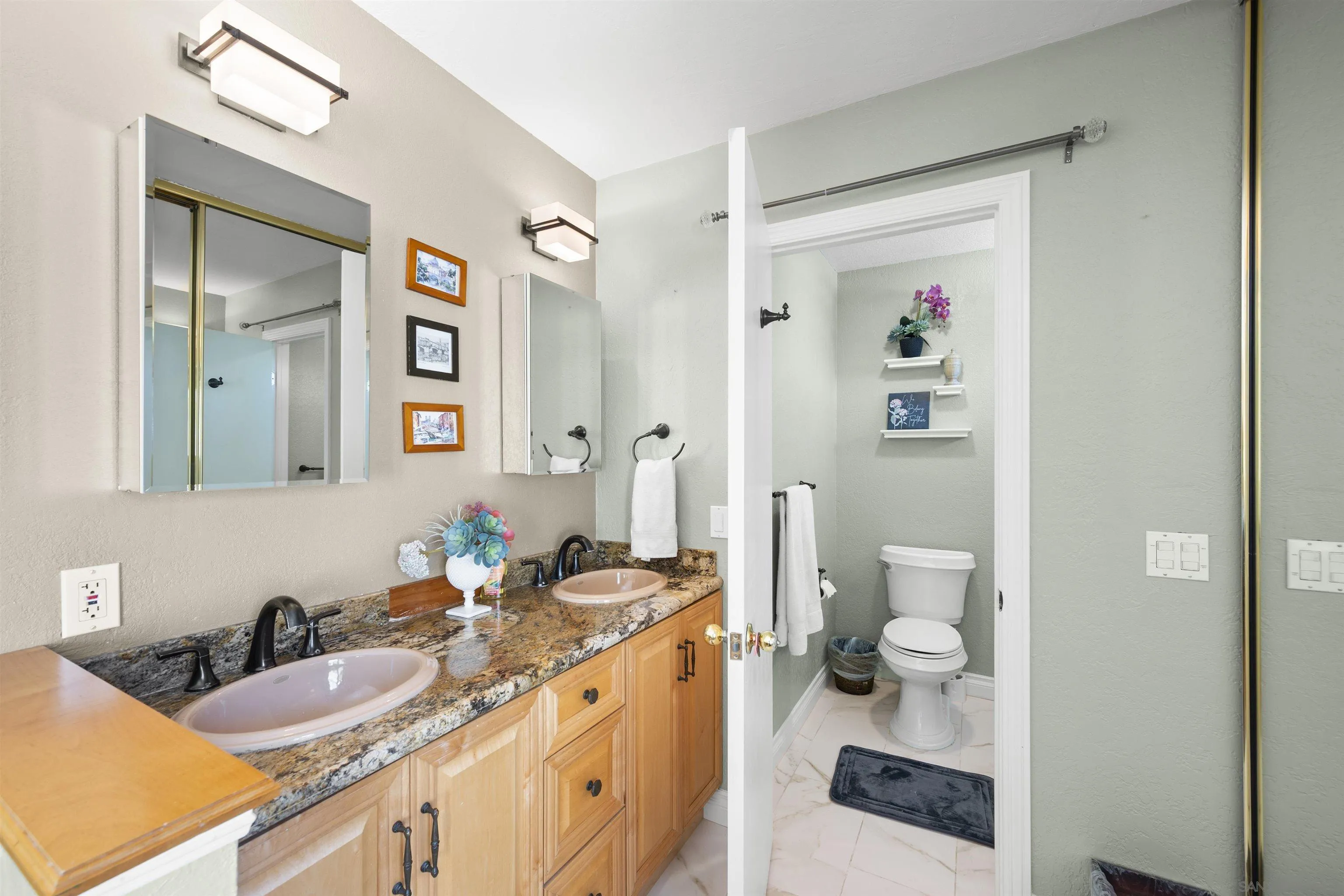 1510 Orangeview Drive, Unit 12 Encinitas, CA 92024 - Photo 33 of 55 a bathroom with a granite countertop double vanity sink mirror and toilet
