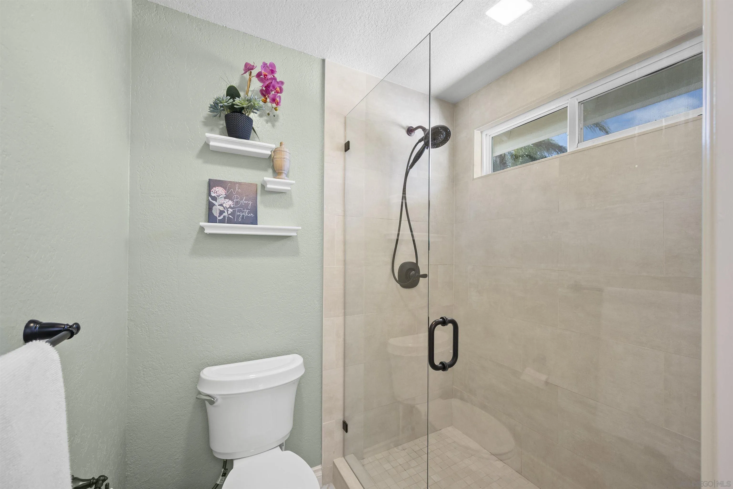 1510 Orangeview Drive, Unit 12 Encinitas, CA 92024 - Photo 34 of 55 a bathroom with a shower and a toilet