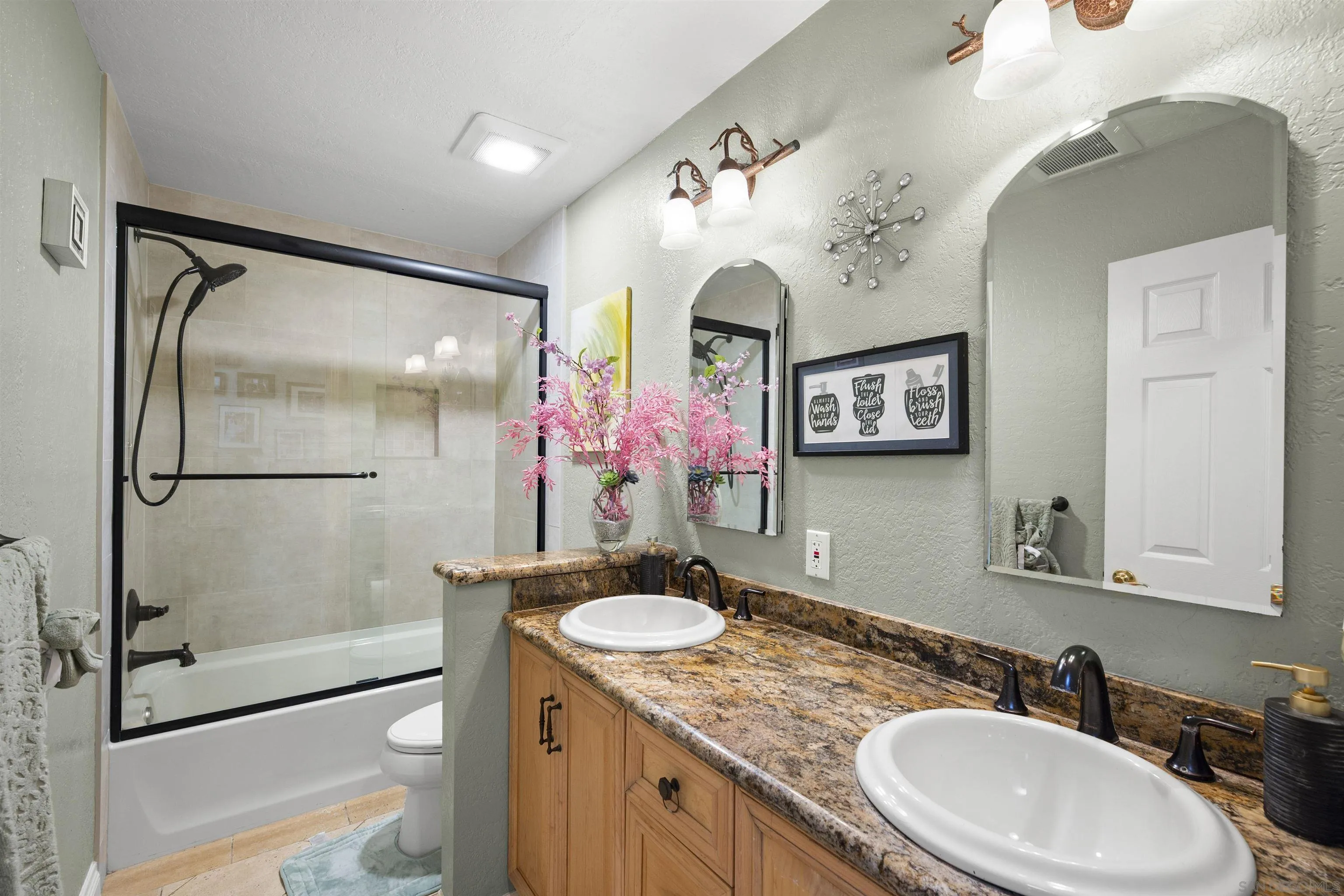 1510 Orangeview Drive, Unit 12 Encinitas, CA 92024 - Photo 37 of 55 a bathroom with a granite countertop sink mirror toilet and shower