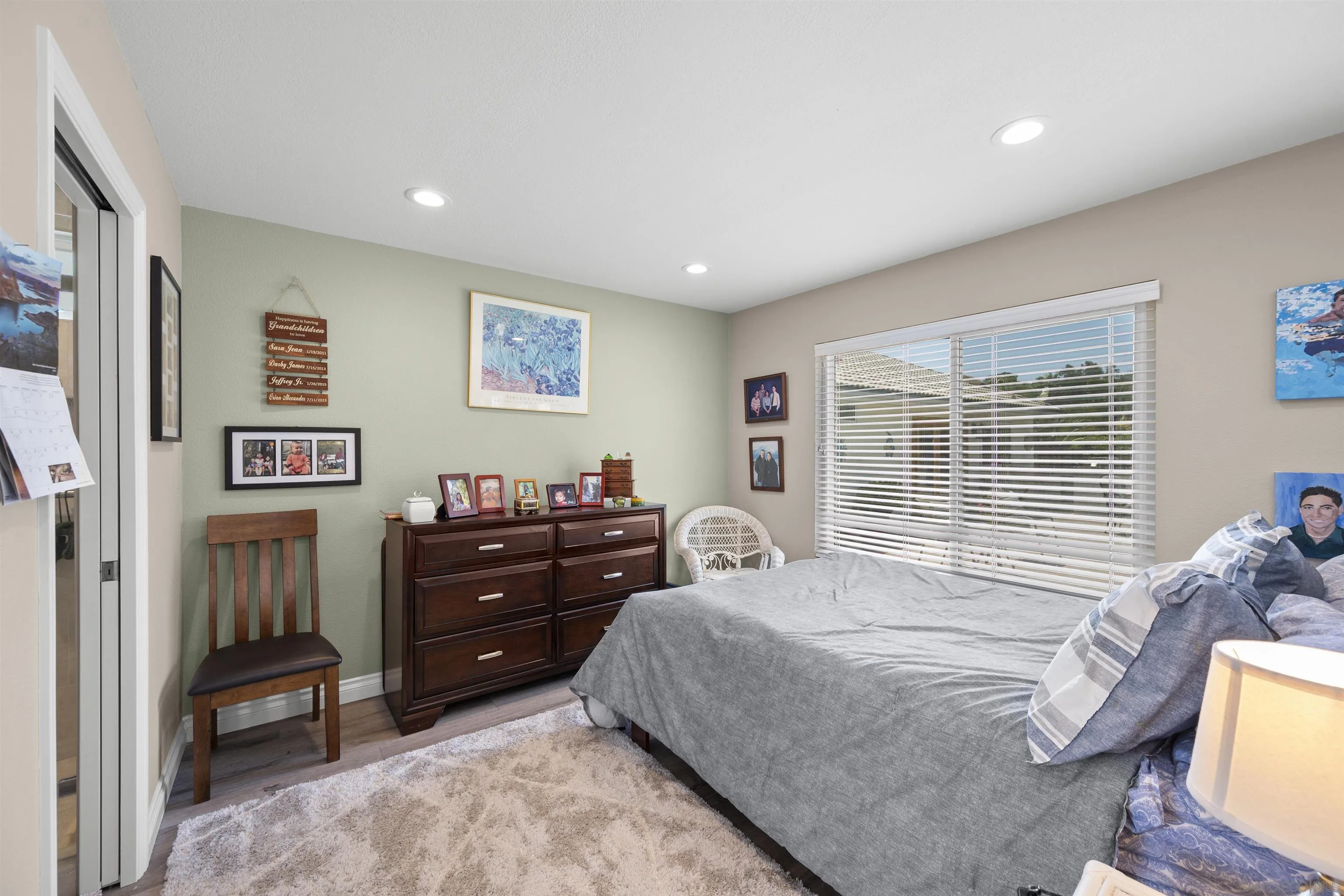 1510 Orangeview Drive, Unit 12 Encinitas, CA 92024 - Photo 48 of 55 a bedroom with a bed and wooden floor