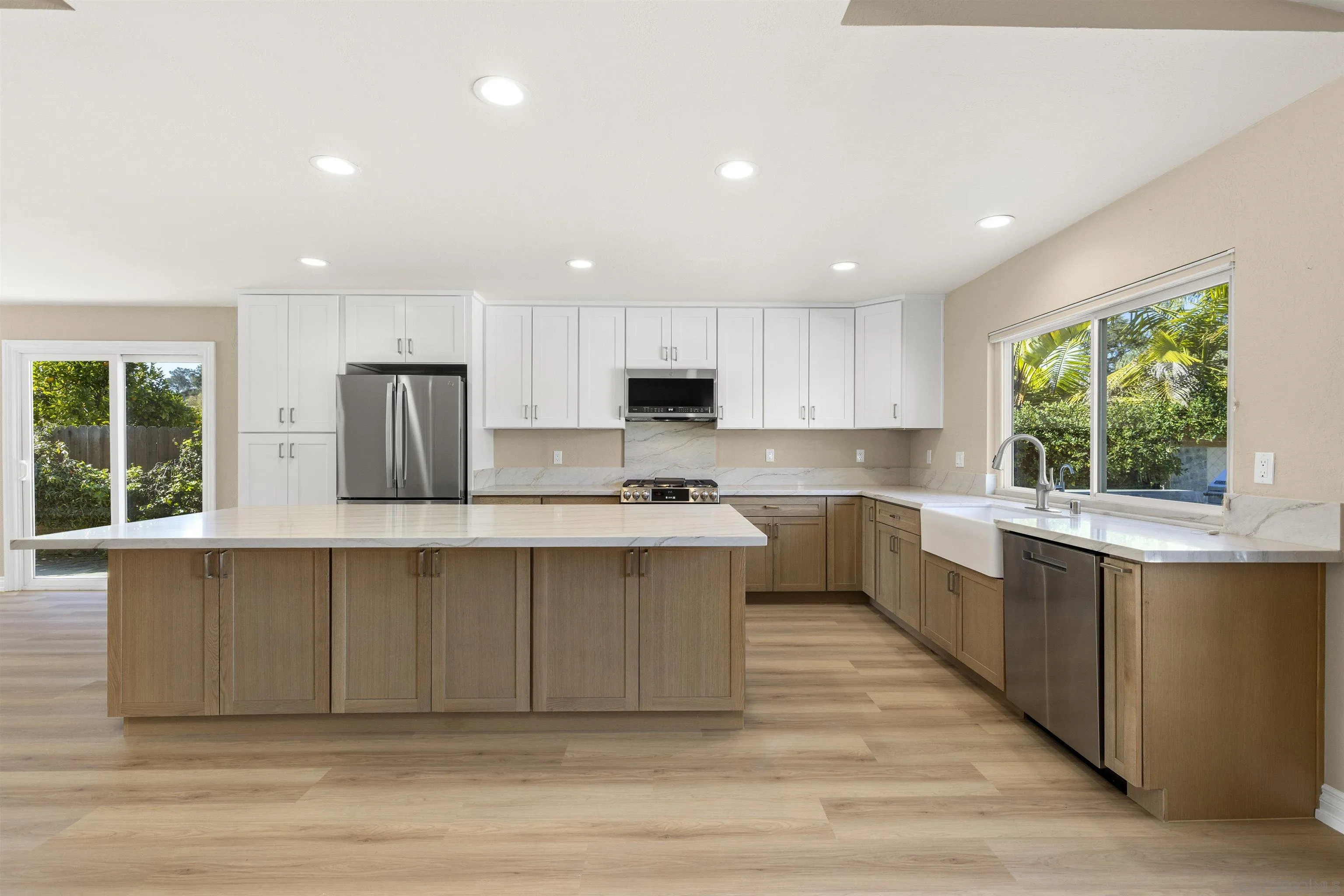 1510 Orangeview Drive, Unit 12 Encinitas, CA 92024 - Photo 7 of 55 a large kitchen with stainless steel appliances a large counter top a stove a refrigerator cabinets and a window