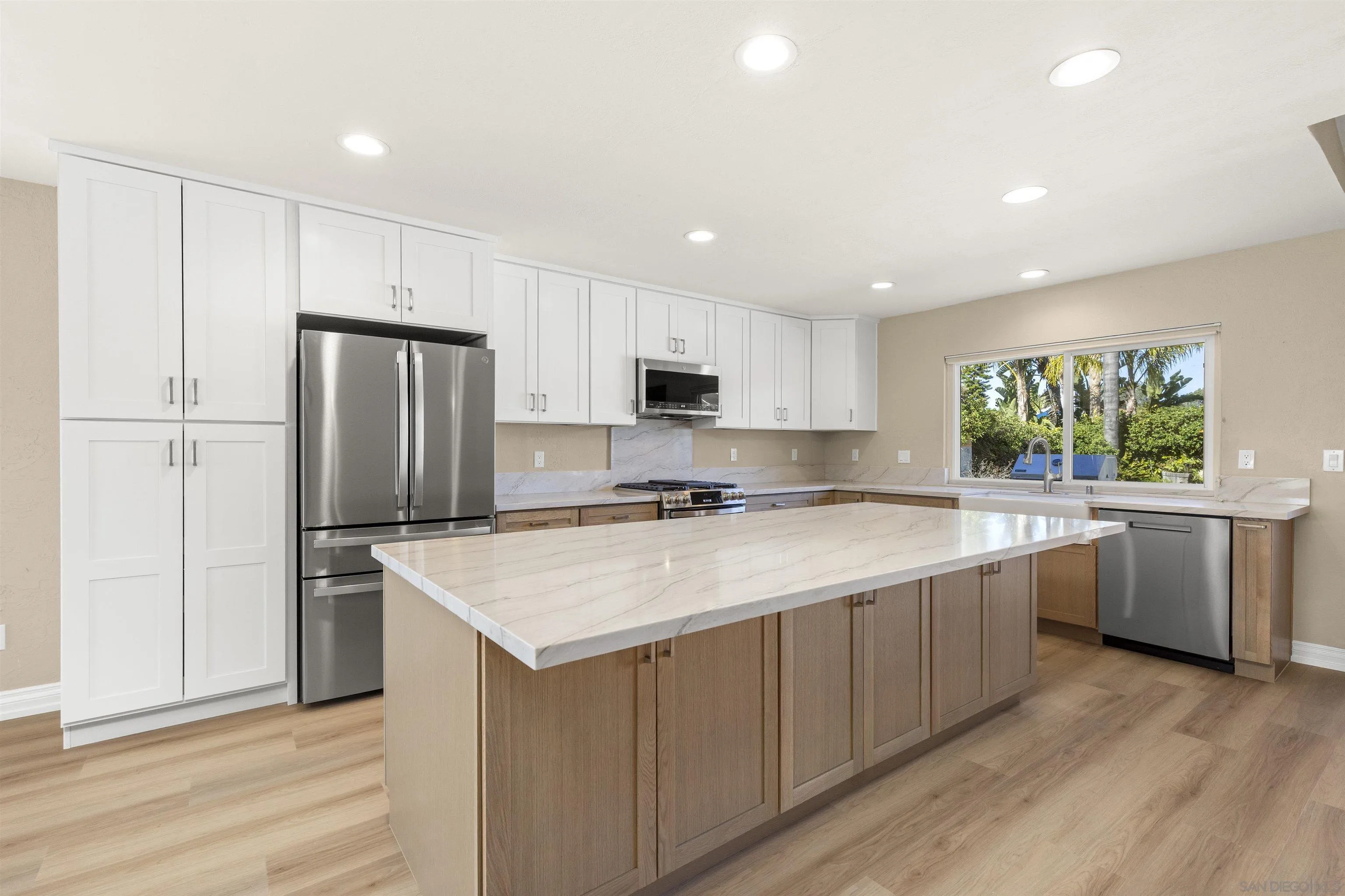 1510 Orangeview Drive, Unit 12 Encinitas, CA 92024 - Photo 8 of 55 a kitchen with a refrigerator a sink and cabinets