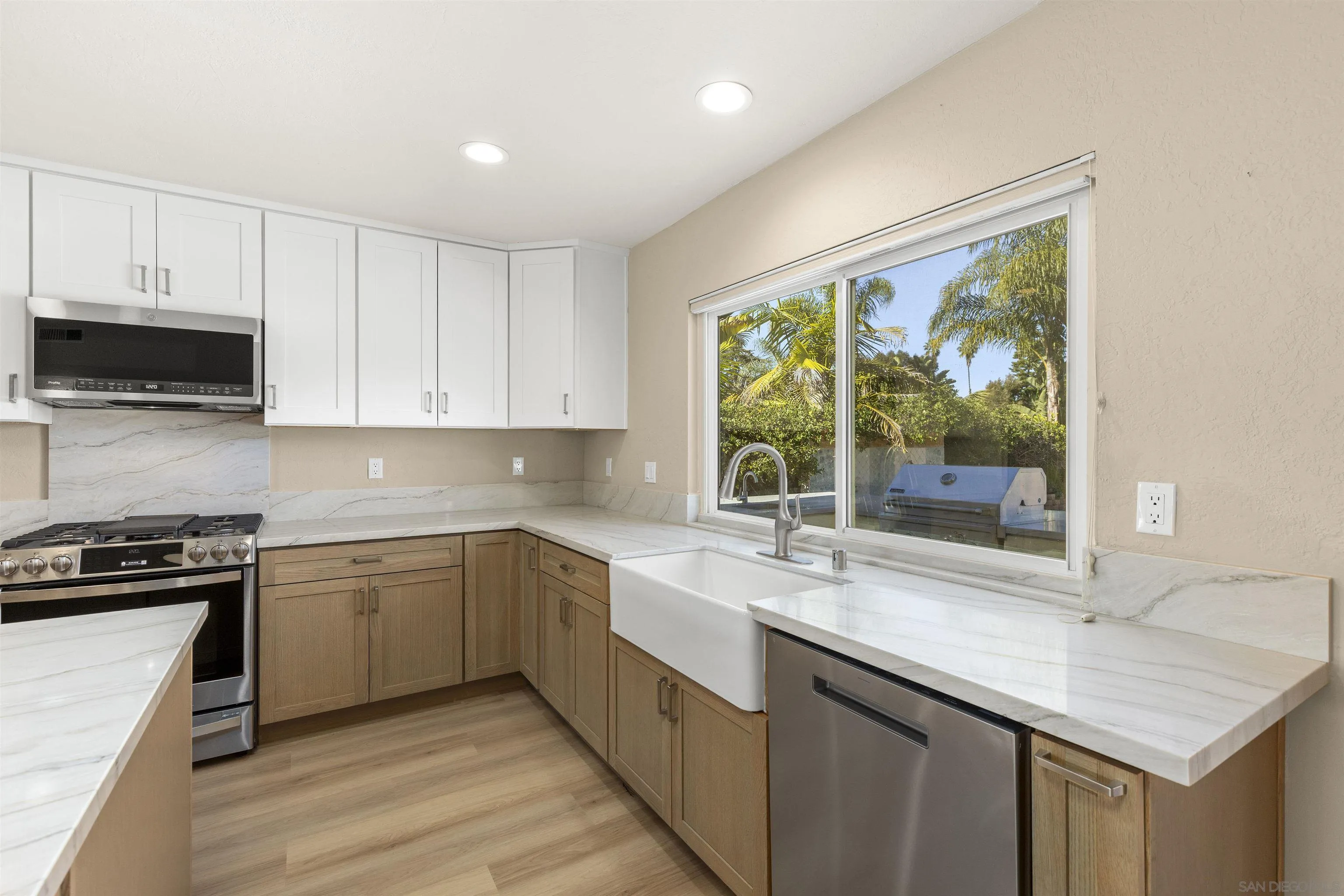 1510 Orangeview Drive, Unit 12 Encinitas, CA 92024 - Photo 9 of 55 a kitchen with a sink stove and cabinets