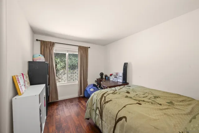 a bed sitting in a bedroom next to a window