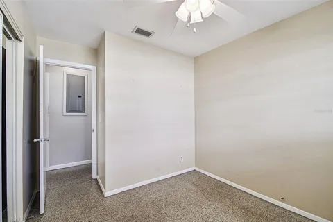 a bathroom with a toilet sink vanity and mirror