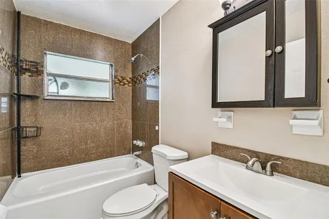 a kitchen with granite countertop a sink and a stove top oven