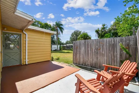 a house that has a big yard with wooden fence