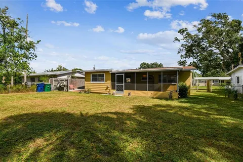 aerial view of a house with yard swimming pool and outdoor seating