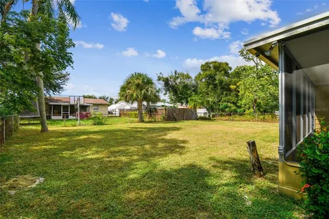 an aerial view of a house with swimming pool and outdoor seating