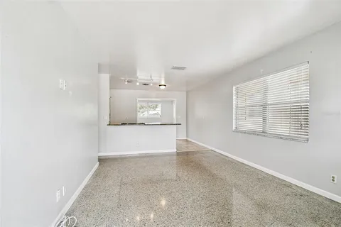 a view of kitchen with refrigerator and window
