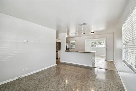 a kitchen with stainless steel appliances kitchen island granite countertop a refrigerator and a sink