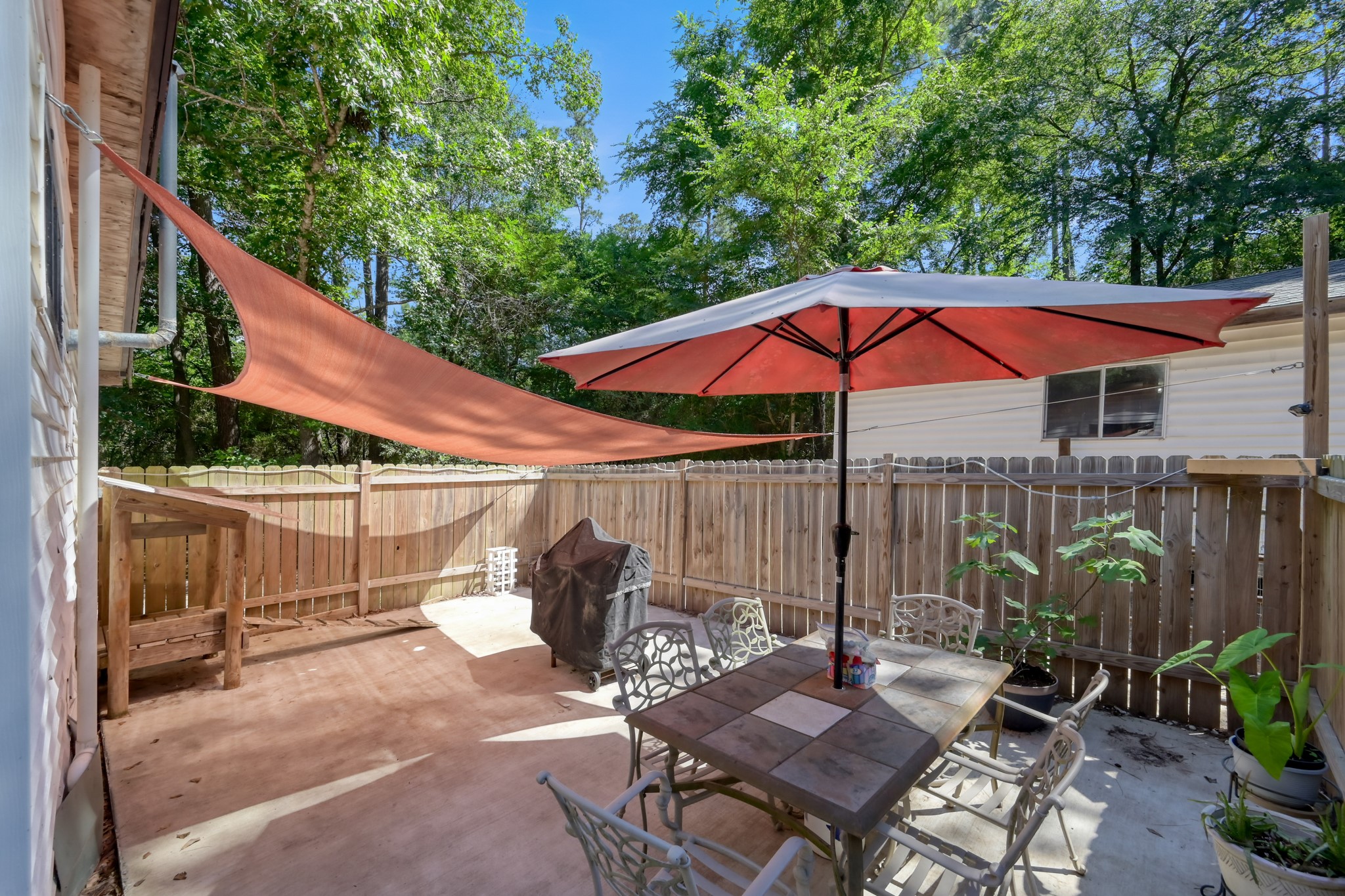 263 Travis Lane Trinity, TX 75862 - Photo 27 of 34 Enclosed patio space on the side of the house perfect for outdoor dining and entertainment