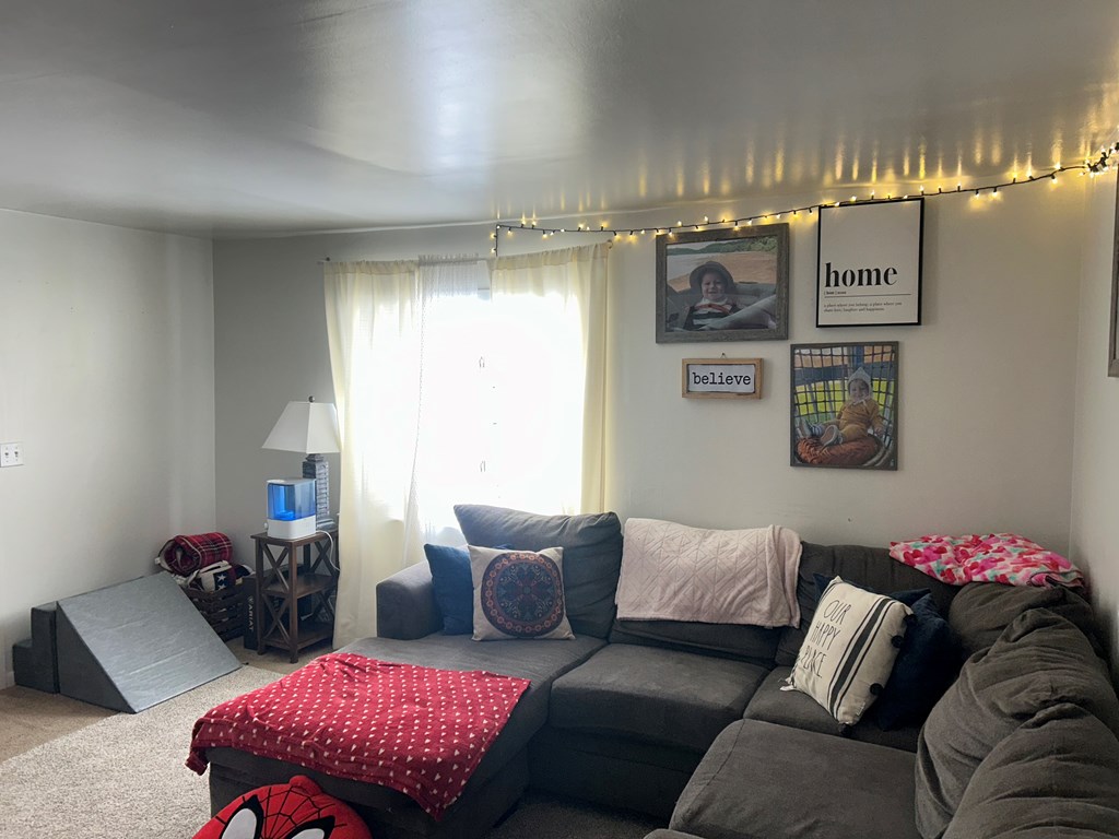 734 Main Street Rimersburg, PA 16248 - Photo 4 of 15 a living room with furniture and a chandelier